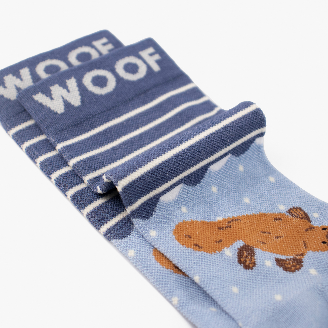 Folded view showing cute platypus illustration on blue bamboo crew compression socks with platypus design.